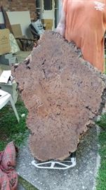 many pieces of redwood ready to be polished and made into tables.