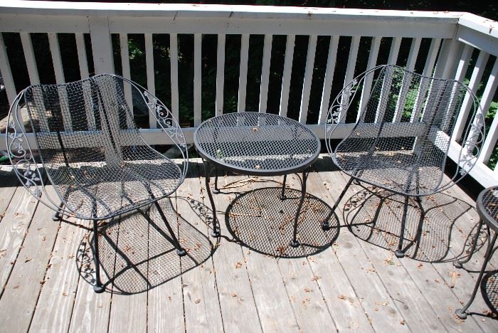 2 wrought iron chairs and table