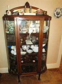 Antique curved glass china cupboard w/ carved head on top