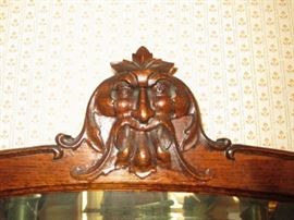 Carved Face on top of curved glass china cupboard