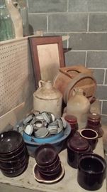 Oak mirror, butter churn, jugs, brown crockery bowls.