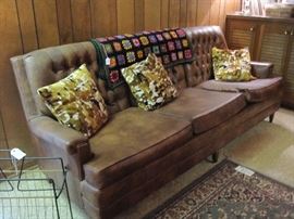 Naugahyde sofa and mid-century modern magazine rack.