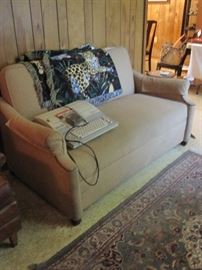 Sleeper sofa and early electric typewriter.