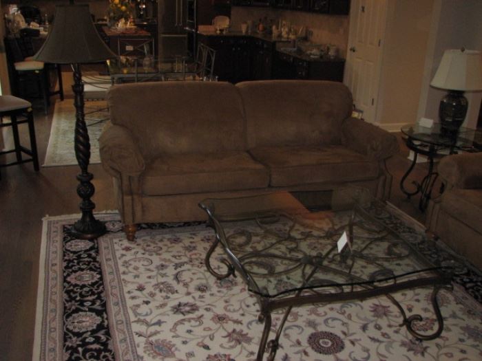 microfiber sofa, large area rug, glass top coffee table