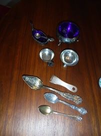 Sterling spoons and salt cellars.