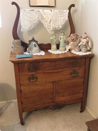 Dresser with harp for dresser towels, washstand actually, lower right doors for storing pitcher and bowl perhaps?
