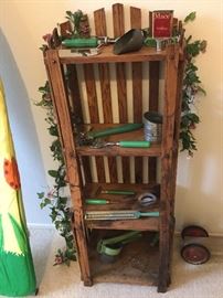 Small wood shelf with vertical slat design, shown with some of the antique kitchen tools with green handles, and they are uber cool