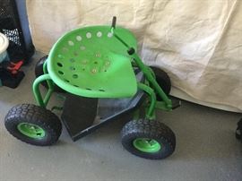 Tractor of some sort, pulled by parents is my guess, ...