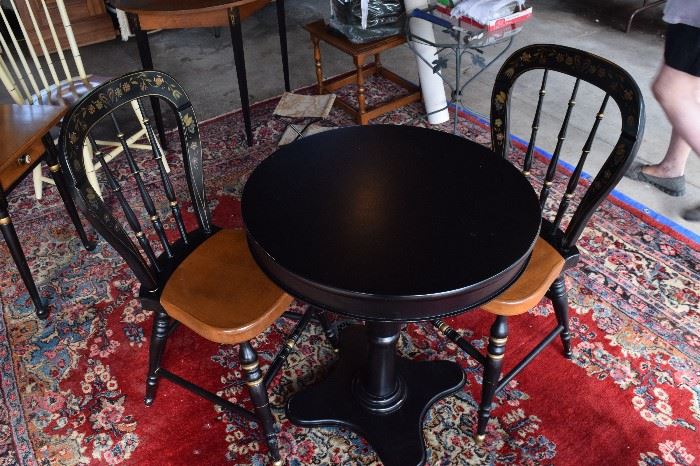 Pair of Hickcock-style vintage chairs paired with modern table.