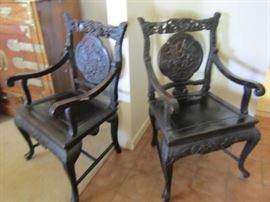 Pair of ornately carved Chinese chairs