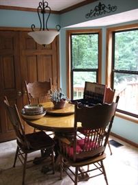 oak table with eight chairs and one large leaf
