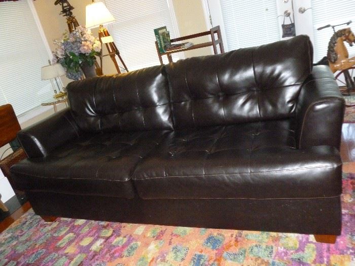 One of a pair of new vinyl (17% leather) sofas