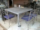 Patio set. This table was made to look rustic and uses old metal wagon wheels as part of it. approx. 4' x 5'. 4 chairs and a bench.