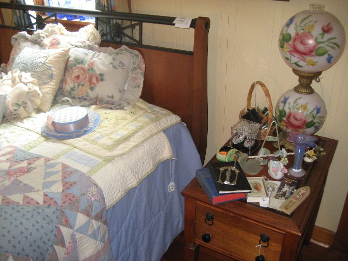 Painted hurricane lamp, antique quilt on bed