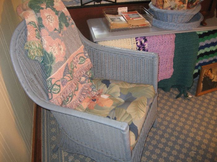 Blue wicker chair, painted blue chest, crocheted throws