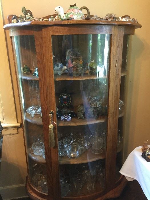 curio with wooden shelves and turtle collection