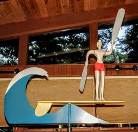 LARGE INDOOR MODERNIST WHIRLIGIG OF A SURFER BOY ON SURFBOARD AND RIDING A WAVE WOOD AND METAL WITH WEIGHTED BASE.  SIGNED NOTED ARTIST: JAMES WARREN 87