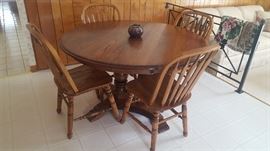 $250 Oak, round table with four chairs and 3 extra leaves