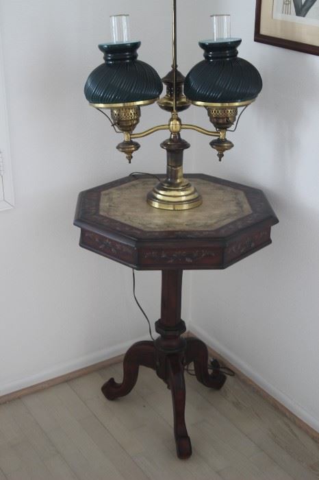 Pedestal table and antique lamp.