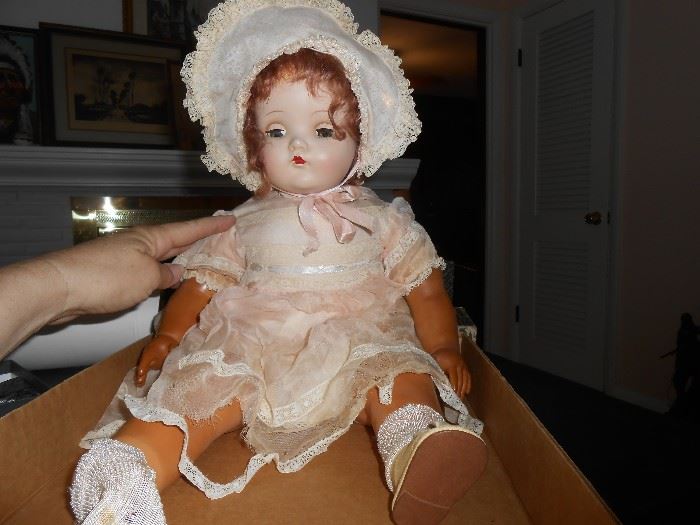 Madame Alexander Little Genius doll shows natural wear. Her eyes open and close. The doll has composition head,
hands, feet and a cloth body. Clothing bears the original
Madame Alexander tag. She is 22 inches long. 1933. This doll has a crier that is no longer working.