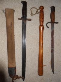 Bayonetss and billy club - The one on the right is German made. Both made similar to swords