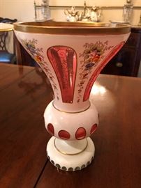 One of two antique matching Bohemian cut Opaline overlay over cranberry with enameling footed vases. 11 ins tall