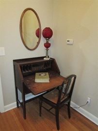 Fold out desk, wicker seat chair, mirror and red hobnail glass lamp