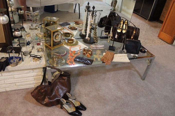 Vintage chrome and glass small coffee table vintage jewelry, purses and shoes. 