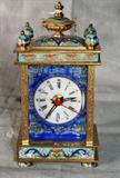 Bronze and champlevé enamel carriage clock, the sides with enamel portrait panels. H: 7 1/4" W: 3 3/4" D: 3 1/4"
