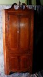 American Cherry corner cabinet, mid 19th century with panel doors and shaped apron on bracket feet. H: 79" W: 36" D: 23"