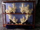 Monumental pair of Chinese heavily carved bone tusks modeled as mountainous temples with figures, foliage, flying cranes and lanterns, signed. Each, H: 40" W: 24" D: 10" (Note: Illustrated with custom shipping frame.)