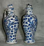 Pair of Antique Chinese Canton porcelain baluster-form vases and covers, decorated with dragons and leafy foliage, the covers with Foo dog finials, four character mark, 19th century or earlier. H: 14"