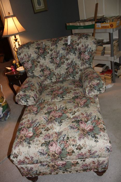 Comfy floral easy chair with ottoman.