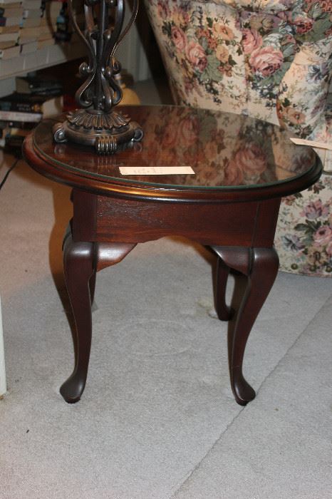 Small traditional side table with glass protector.