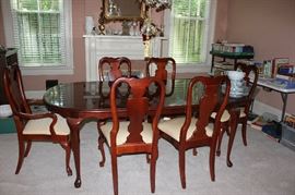 Dining table seats 6 comfortably.  Has leather protector pad.