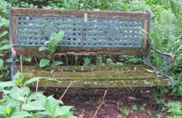 Mossy wood and metal garden bench 