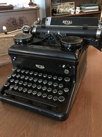 Antique Royal Typewriter with a roll of tape. 