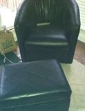 One of a pair of Leather Barrel Back Chairs with Ottomans.