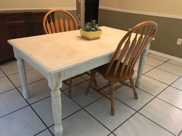 Distressed table.  Shown with two chairs that match the dining table.