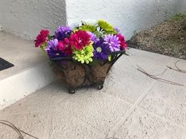 One of two plant containers with faux florals
