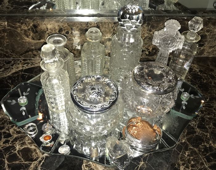 collection of cut glass perfume bottles and powder jars