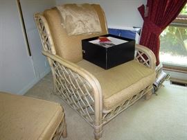 RATTAN CHAIR AND MATCHING OTTOMAN.