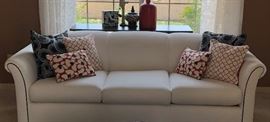 White Sofa w Black Piping, Asst Pillows, Sofa Table and Decor 