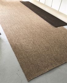 Two rugs -- a brand-new sisal area rug for screened porch, approx. 18' x 6' and a rich 10' x 22' brown carpet. 