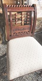 Unusual Aesthetic period chair with ornate back and reupholstered seat. 