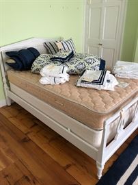 Vintage double bed painted white with linens