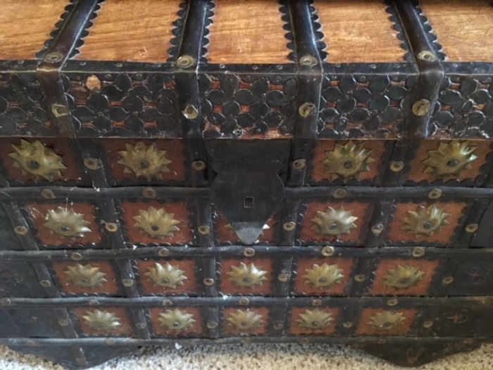 Detail of wood and elaborate brass studded chest 