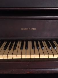 Upright piano with original keys and works by Hobart M. Cable 