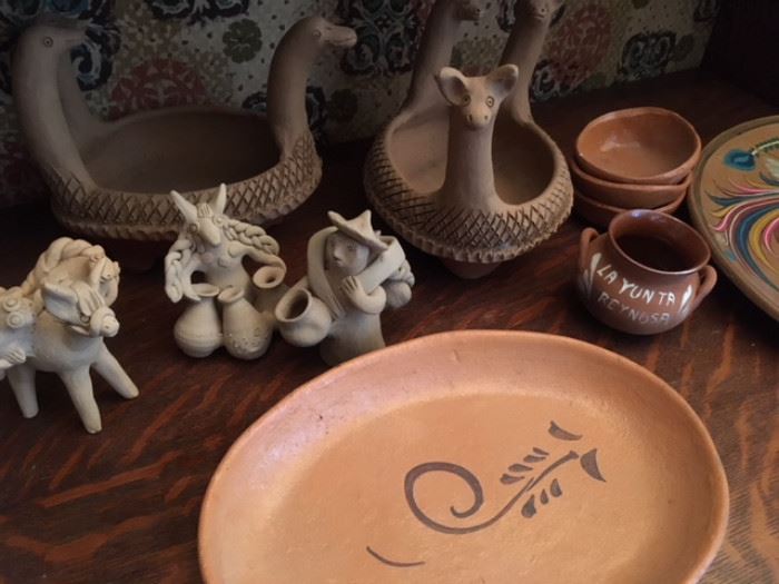 Assorted unpainted and painted clay tourist collectibles from Mexico