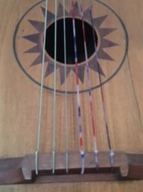 Detail of sound hole, strings & bridge of bass guitarron